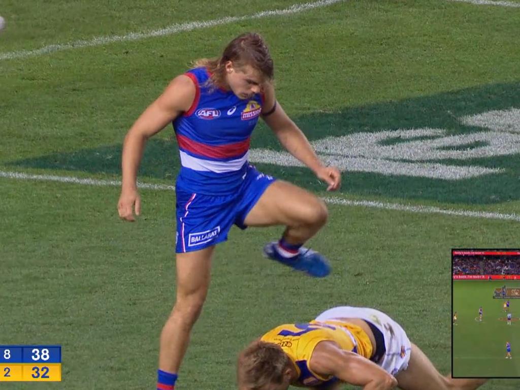 Bailey Smith steps over Brad Sheppard after kicking a goal.