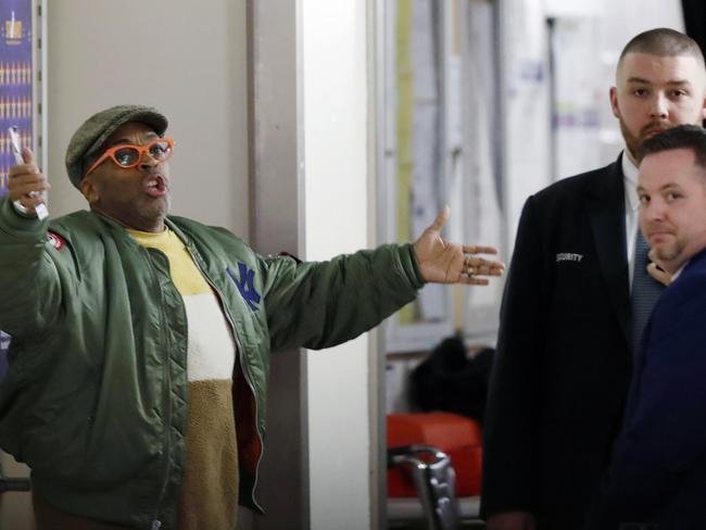 Director Spike Lee, left, gestures in a hallway on the event level at Madison Square Garden while arguing with security officers who didn't want to permit him to access his court side seat before the start of an NBA basketball game between the New York Knicks and the Houston Rockets in New York, Monday, March 2, 2020. Lee later spoke with Knicks owner James Dolan and security and was allowed to get to his seat to watch the game. (AP Photo/Kathy Willens)