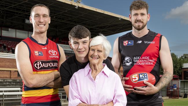 Barb Kerley wife of Neil with grandson Campbell Hossack, and Jack Madgen of the Adelaide Crows and Kaiden Brand from West Adelaide at Richmond Oval. Picture: Sarah Reed