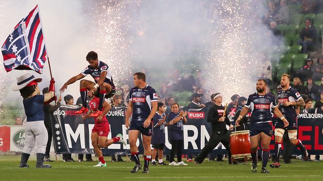 The Rebels run through fireworks onto the field for the round 12 Super Rugby match versus the Queensland Reds.