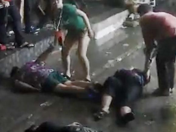 In this April 13, 2016 image taken from video released by the Hua Hin Municipality an elderly British couple and their son are on the ground after they were savagely attacked during a family vacation in Hua, Hin, Thailand. A video of the attack, which was captured by overhead security cameras and posted this week on social media, has stirred shock and outrage over its brutality and the ages of the elder victims, a 65-year-old woman and 68-year-old man from Scotland. The attack marks the latest act of violence against tourists in the Southeast Asian country. (Hua Hin Municipality via AP)