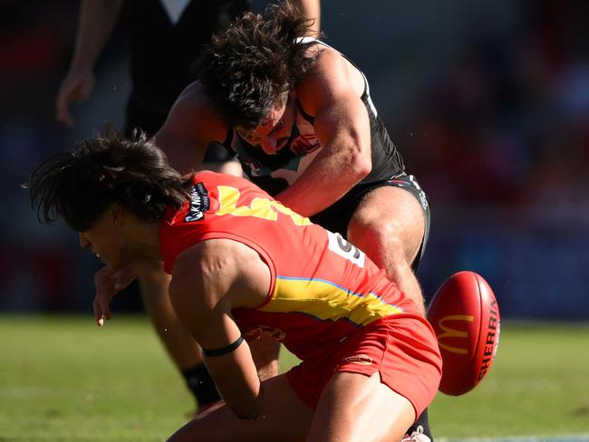 Lachie Jones is hit high by Alex Davies. Picture: Getty Images