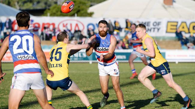 Central District’s Isaya McKenzie gets his handball away against the Eagles. Picture: AAP Image/ Morgan Sette