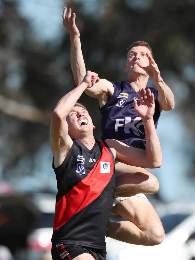 Katandra’s Talon Wilson rises over Waaia coach Mitch Cleeland in the grand final. Picture Yuri Kouzmin