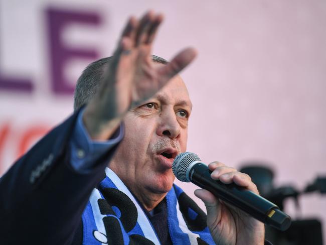 Turkish President Recep Tayyip Erdogan sings his election song before delivering a speech at an election rally in Istanbul's Kasimpasa district, on March 5, 2019. - Turkish leader is picking up the microphone to croon, complete with hand gestures, as he campaigns for March 31 ballot to rally supporters for his ruling AKP party.Music has always been a powerful tool in Turkish politics but with Erdogan and his Justice and Development Party (AKP), it has become an indispensible weapon. (Photo by Ozan KOSE / AFP)