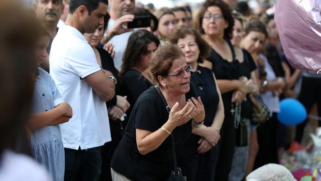 The Abdallah family mourning at the crash site. Picture: Jonathan Ng