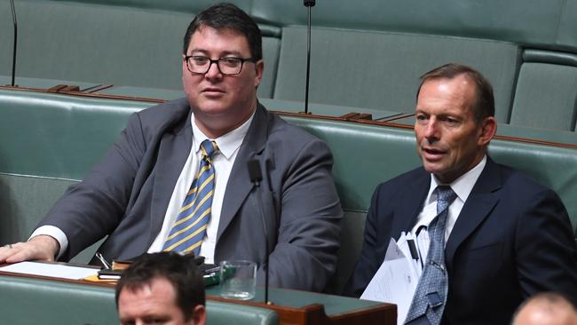 George Christensen (left) sits with former prime minister Tony Abbott, who toyed with becoming a Catholic priest as a young man.