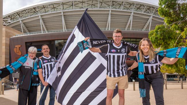 Port Adelaide fans Margie Gill and Luke May with Andrew Fuss and Ruby McHaffie on the Footbridge to the Adelaide Oval. Picture: Ben Clark