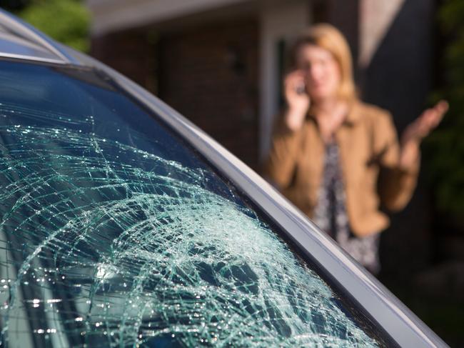 Woman Phoning For Help After Car Windshield Has Broken, car insurance generic windscreen cracked