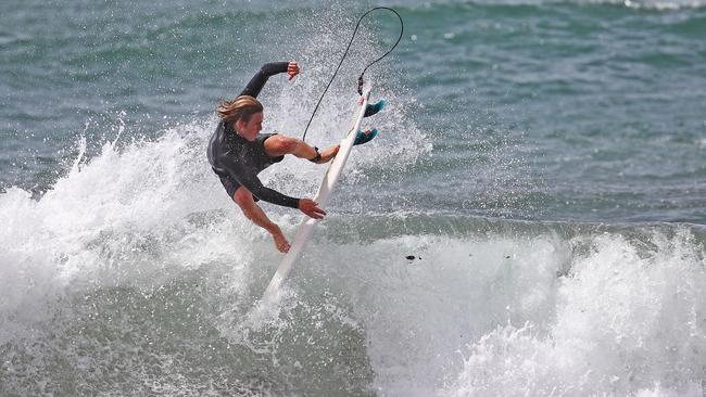 A surfer catches a wave at Collaroy on Friday. Picture: Toby Zerna