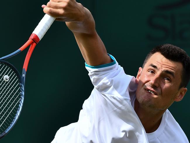 Australia's Bernard Tomic serves against France's Jo-Wilfried Tsonga during their men's singles first round match on the second day of the 2019 Wimbledon Championships at The All England Lawn Tennis Club in Wimbledon, southwest London, on July 2, 2019. (Photo by Ben STANSALL / AFP) / RESTRICTED TO EDITORIAL USE