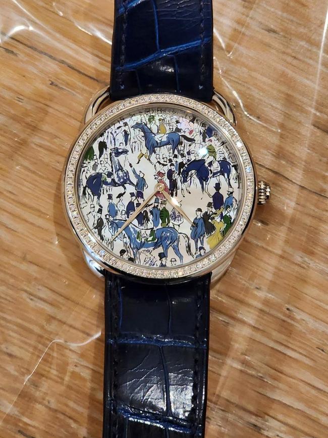 Cash and designer watches were some of the items seized following the arrests. Picture: AFP