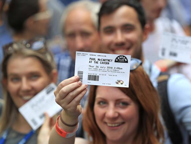 Fans brandish their tickets as they queue outside the Cavern Club. Picture: Peter Byrne/PA via AP