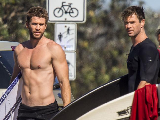 Whether bearded or stubbled, the Hemsworth brothers always seem to pull off a good look. You’d be laughing too. Chris appeared happy and relaxed before his surf session. Picture: Media-Mode