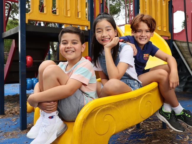 Nine-year-olds Jacob Meddows, Alex Nguyen, and Jemma Khong are excited to get the jab. Picture: Toby Zerna