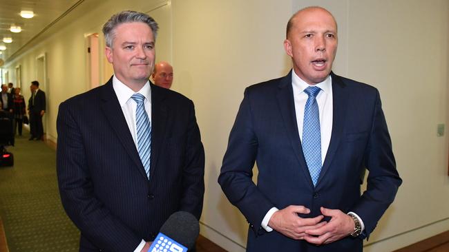 Mathias Cormann and Peter Dutton leave the Liberal Party room meeting at Parliament House in Canberra last August.