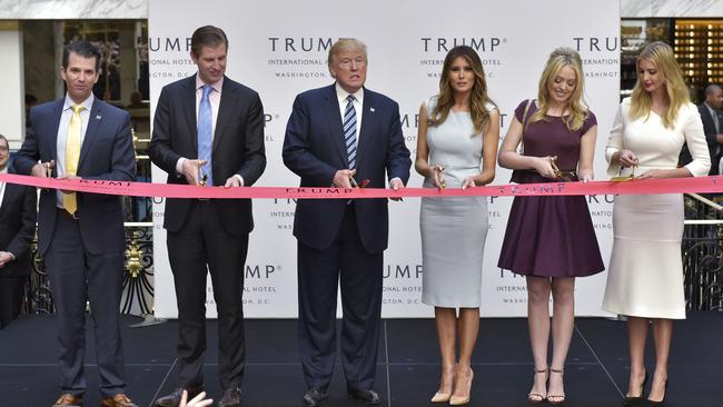 From left: Donald Trump Jr, Eric Trump, Donald Trump, Melania Trump, Tiffany Trump, and Ivanka Trump take part in a ribbon cutting ceremony during the grand opening of the Trump International Hotel in Washington, DC in 2016.