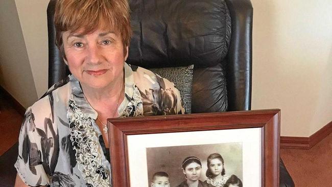 MEMORIES: Helen Perikkentis holds a photograph of her family she immigrated to Australia with in 1959. Picture: CONTRIBUTED