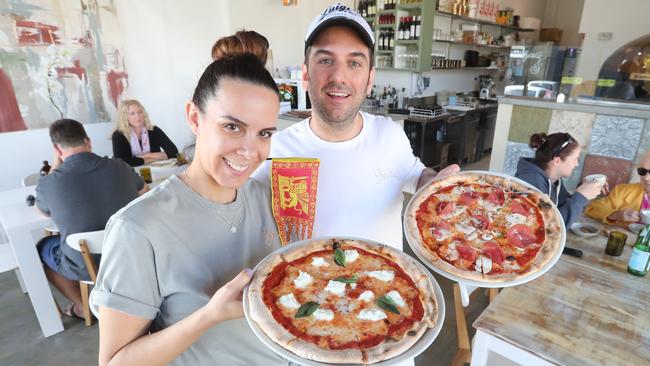 Anna Gazzola and Loris Perobello holding a couple of their new pizzeria’s spoils. Photo by Richard Gosling