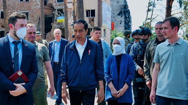 Jokowi and Iriana, centre, tour the devastation in the commuter suburb of Irpin on Wednesday. Picture: AFP