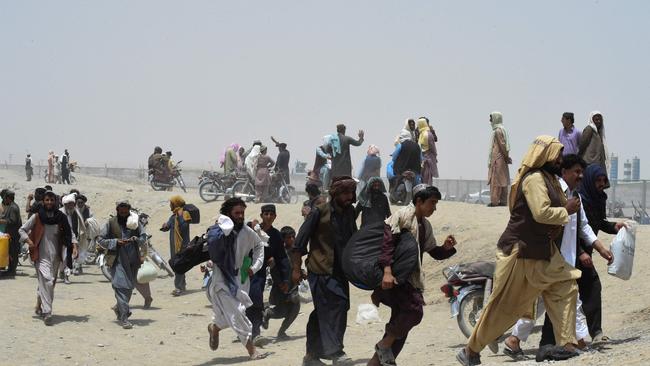 People rush towards a border crossing point in Pakistan's border town of Chaman on July 17. Picture: AFP