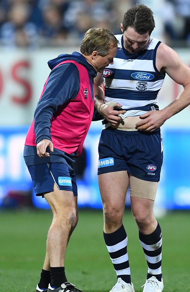 Patrick Dangerfield shows the club doctor his hip issue during Friday’s win against Adelaide. Picture: Quinn Rooney/Getty Images.