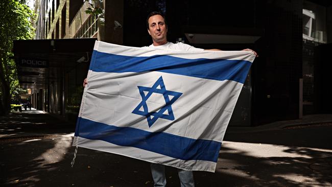 Mark Spiro was carrying an Israeli flag and was arrested for his own safety at a pro-Palestine rally that moved from Sydney Town Hall to the Opera House. Picture: Adam Yip