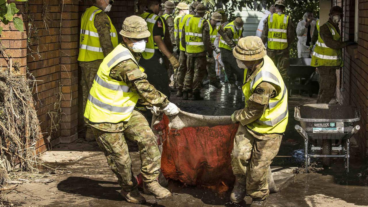 ADF personnel remove a saturated carpet from a house in Taree, NSW during Operation NSW Flood Assist. Picture: NCA NewsWire / Gary Ramage