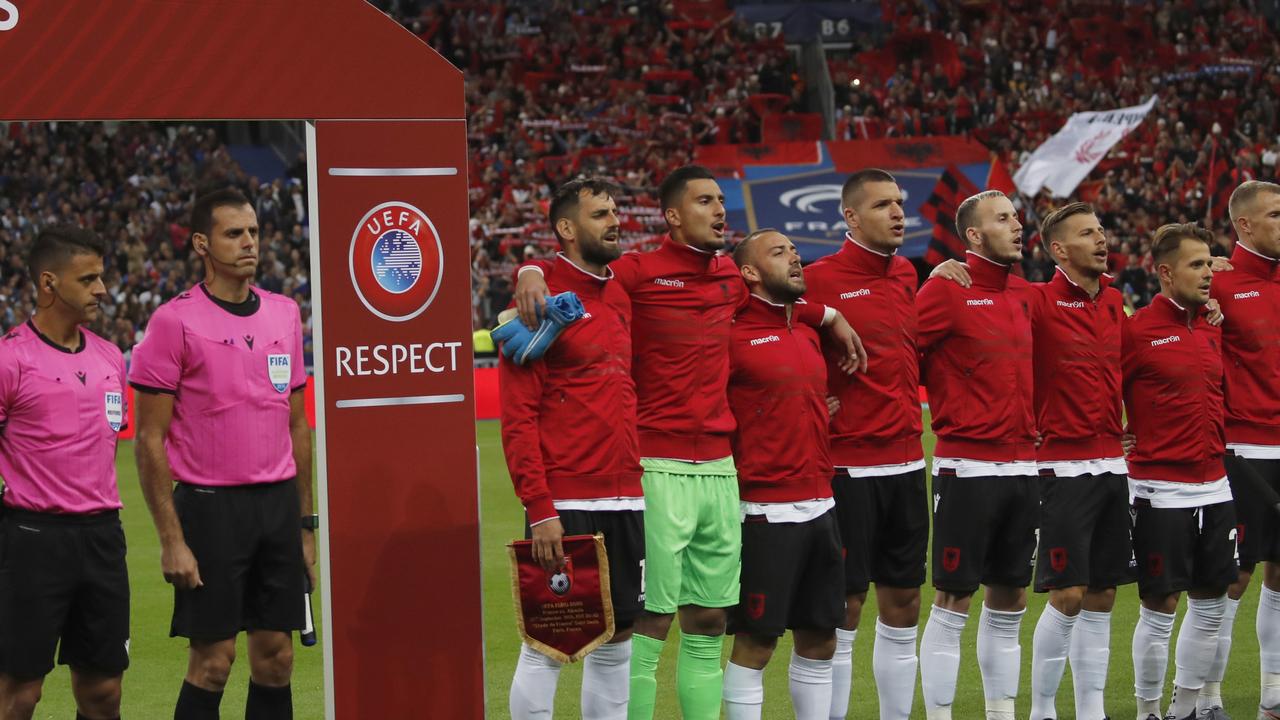 The Albanian team was happy when their anthem was finally played. (AP Photo/Christophe Ena)