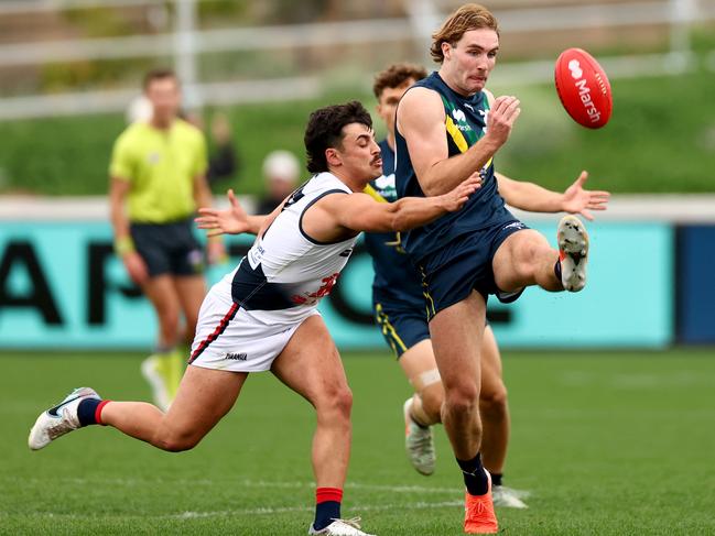 MELBOURNE, AUSTRALIA - APRIL 27: Dyson Sharp of the AFL National Academy kicks under pressure from Josh D'Intinosante of Coburg during the Marsh AFL National Academy Boys match between Australia U18 and Coburg VFL at Whitten Oval on April 27, 2025 in Melbourne, Australia. (Photo by Josh Chadwick/AFL Photos/via Getty Images)