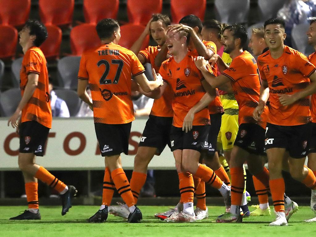 Corey Brown (centre) is congratulated by his Brisbane Roar teammates after scoring against Macarthur FC. Picture: Jono Searle/Getty Images