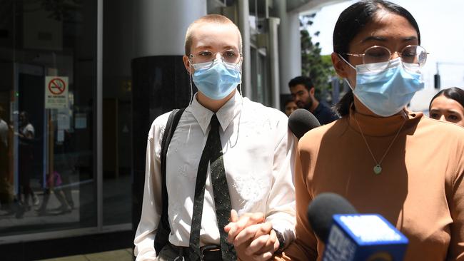 Tyler Michelle Hingst (left in white shirt) leaves Brisbane Arrests Court in the company of supporters, following her first appearance on a charge of public nuisance. Picture: NCA NewsWire / Dan Peled