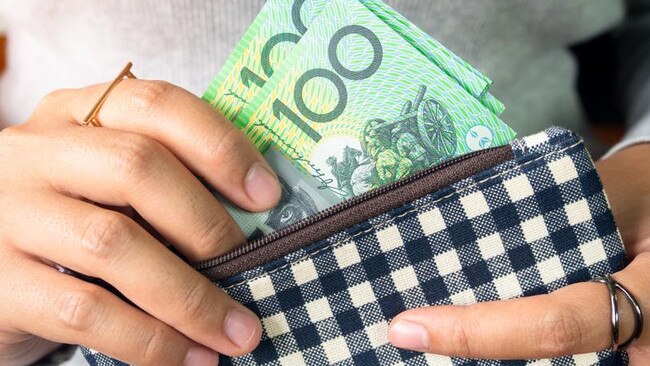 Woman put dollar australia money into wallet.