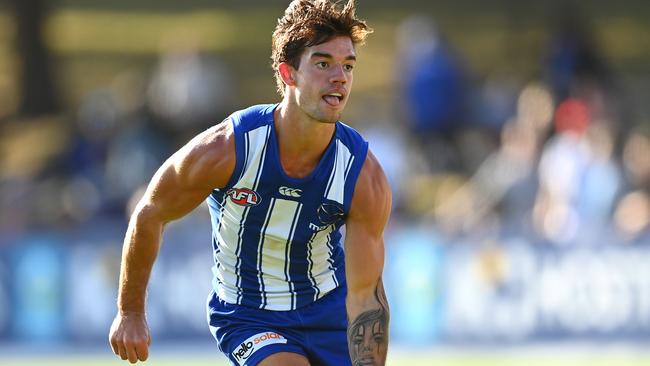 MELBOURNE, AUSTRALIA - MARCH 06: Jy Simpkin of the Kangaroos handballs during the AFL Community Series match between the Hawthorn Hawks and the North Melbourne Kangaroos at Arden Street Ground on March 06, 2021 in Melbourne, Australia. (Photo by Quinn Rooney/Getty Images)