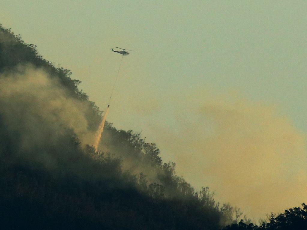 A waterbombing chopper works on a nearby fire in the Scenic Rim on Wednesday. Picture: David Clark