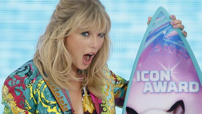 Taylor Swift busts out her surprised face when winning an icon award. Pic: Danny Moloshok/Invision/AP