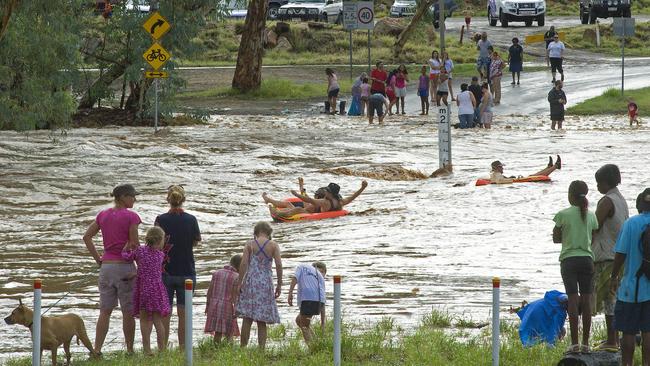 Todd River in Flood. At the Swartz Crescent Causeway locals take in the power of the Todd River coming down. Despite the PFES advising not to do so, thrill seekers still tempted to take to the river on rubber rafts from KMart. At the same time this picture was taken, a 24 year-old local man drowned in the rapids north of the town at Wigglies Waterhole. Picts by Barry Skipsey