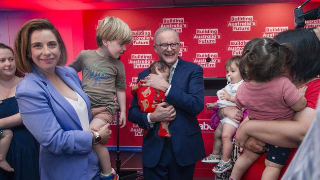 Prime Minister Anthony Albanese holds baby Maise after announcing his government’s childcare policy - including a 10 per cent pay rise for workers - in Brisbane on December 11. Picture: NewsWire / Glenn Campbell