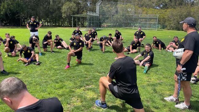 Flanagan (standing on right) addressing the squad. Picture: Facebook/Macedonia Rugby League