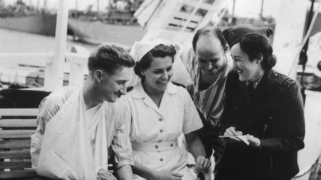 Lorraine Stumm, reporter for the Sydney Daily Telegraph and London Daily Mirror, interviewing on a hospital ship in Tokyo harbour in September 1945. Picture: Private collection