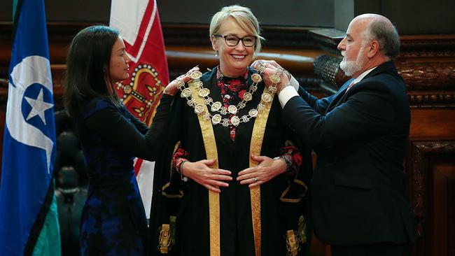 Sally Capp is fitted with her new mayoral robes during yesterday’s swearing in at Melbourne’s Town Hall. Picture: Ian Currie