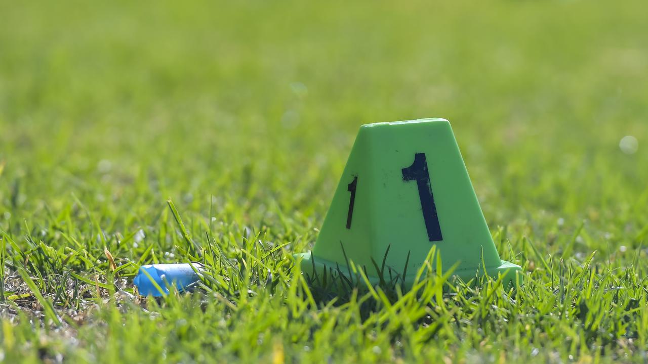 A spent shotgun cartridge beside a police evidence marker at the scene at Kilburn on Wednesday morning. Picture: Roy VanDerVegt