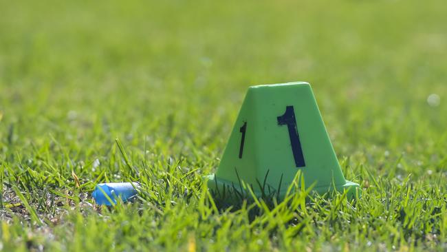 A spent shotgun cartridge beside a police evidence marker at the scene at Kilburn on Wednesday morning. Picture: Roy VanDerVegt