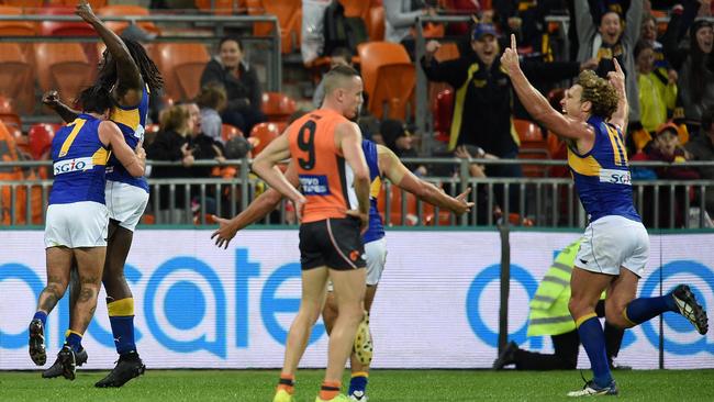 West Coast players celebrate as Tom Scully looks on.