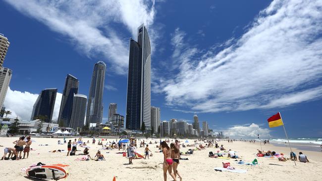 Lifeguards at Surfers Paradise beach keep an eye on beachgoers and keep them swimming between the flags on one of the busiest days of the year. A beautiful beach day at Surfers Paradise. Picture: Glenn Hampson