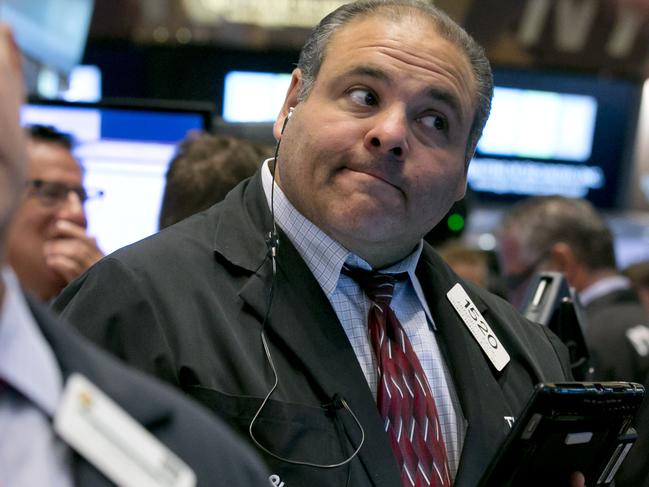 Trader Anthony Riccio works on the floor of the New York Stock Exchange Tuesday, Aug. 11, 2015. U.S. stocks opened lower on Tuesday, led by declines in energy and materials stocks as commodities prices dropped. Prices for oil and copper fell sharply after China's government lowered the value of its currency, suggesting weakness in the world's second-largest economy. (AP Photo/Richard Drew)