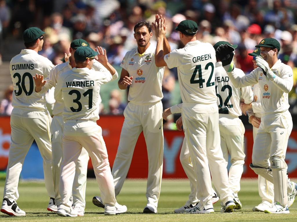 Mitchell Starc celebrates with Cameron Green and his Australian teammates after taking the wicket of Ben Stokes at the MCG. Picture: Robert Cianflone/Getty Images