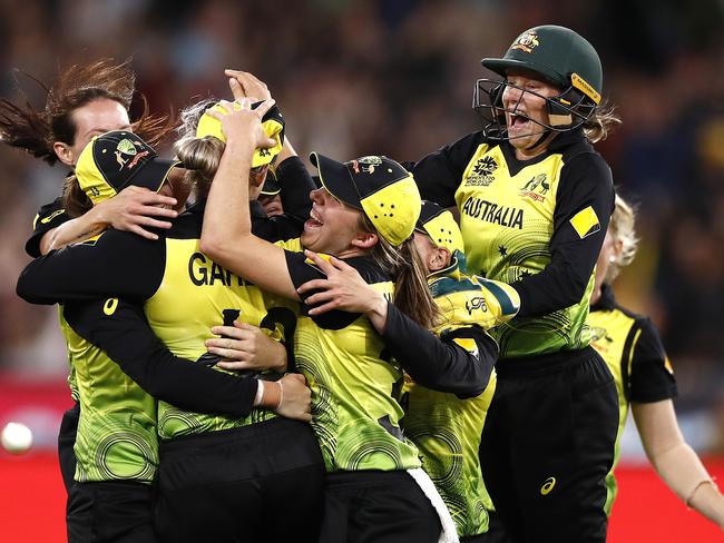 The Australian team celebrates its crushing 85-run victory.