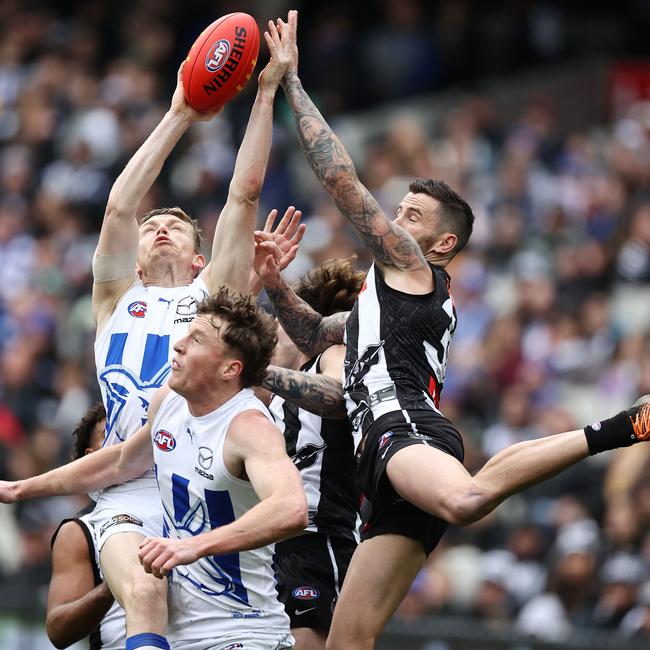 MELBOURNE. 09/07/2022 . AFL . Round 17. Collingwood vs North Melbourne at the MCG. Jeremy Howe of the Magpies floats in to spoil Jack Ziebell of the Kangaroos mark . Photo by Michael Klein