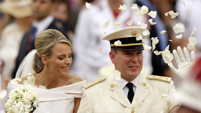 Prince Albert and Princess Charlene leave the Monaco palace after their religious wedding ceremony in 2011. AP Photo/Joel Ryan, pool